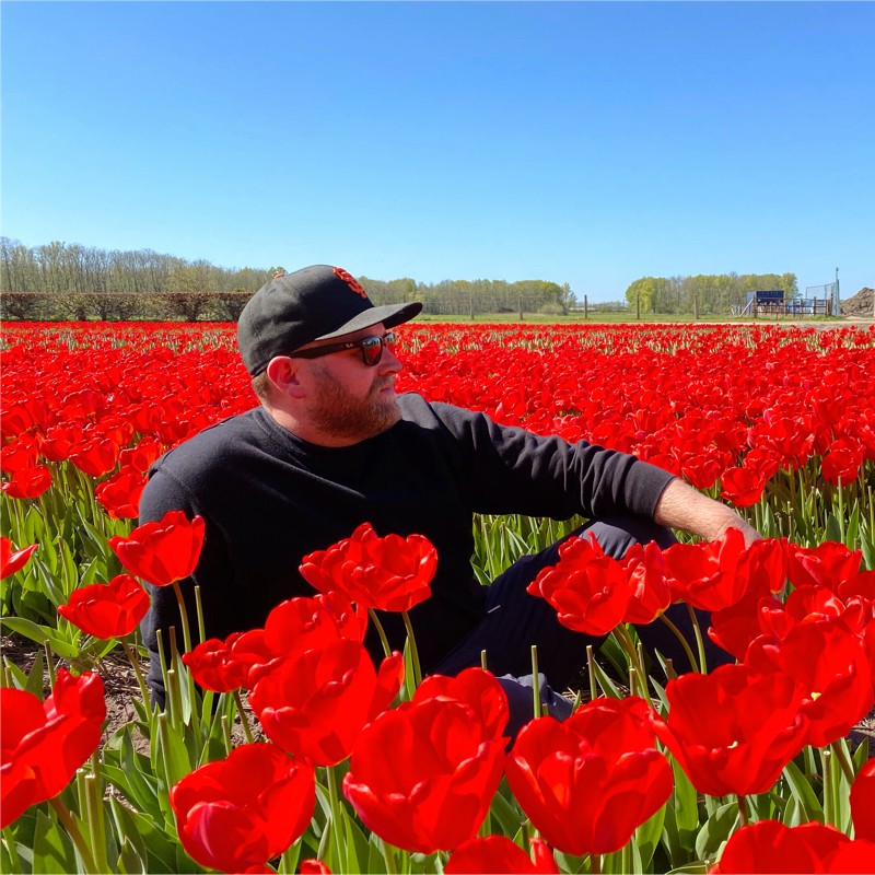 Simon in a field of red tulips